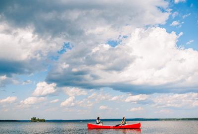 Two people in a red canoe on Sebago Lake